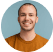 Smiling man in an orange shirt.