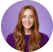 Smiling woman with long red hair.